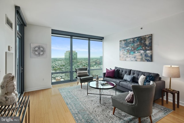 2101 Market St Unit 3605, Philadelphia, PA 19103 - living room with floor to ceiling windows, light wood finished floors, and baseboards