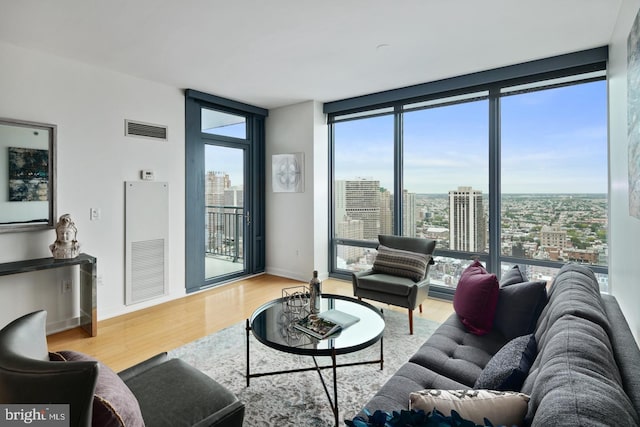 2101 Market St Unit 3605, Philadelphia, PA 19103 - living area featuring a city view, wood finished floors, a wall of windows, and baseboards