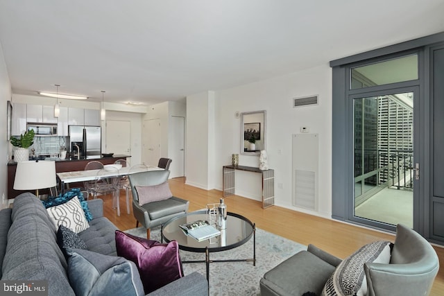 2101 Market St Unit 3605, Philadelphia, PA 19103 - living room featuring light wood-style flooring and baseboards