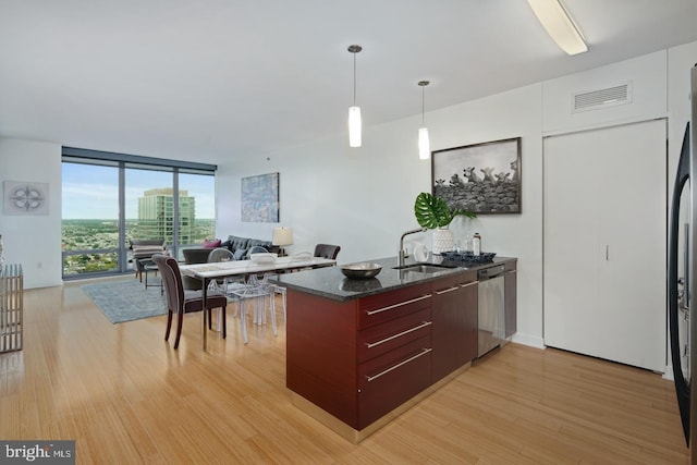 2101 Market St Unit 3605, Philadelphia, PA 19103 - kitchen with a sink, stainless steel dishwasher, light wood-type flooring, expansive windows, and modern cabinets