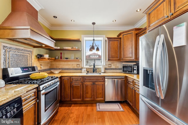 1 S Bartram Ave Unit 3, Atlantic City, NJ 08401 - kitchen with stainless steel appliances, a sink, light wood finished floors, brown cabinetry, and custom exhaust hood