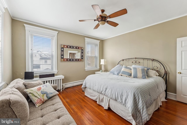 1 S Bartram Ave Unit 3, Atlantic City, NJ 08401 - bedroom with a baseboard heating unit, hardwood / wood-style flooring, crown molding, baseboards, and a ceiling fan