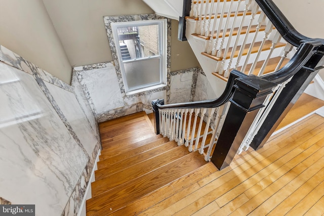 1 S Bartram Ave Unit 3, Atlantic City, NJ 08401 - staircase with wood-type flooring, wainscoting, and tile walls