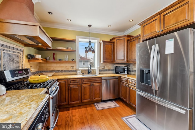 1 S Bartram Ave Unit 3, Atlantic City, NJ 08401 - kitchen featuring appliances with stainless steel finishes, a sink, premium range hood, brown cabinetry, and light wood-style flooring