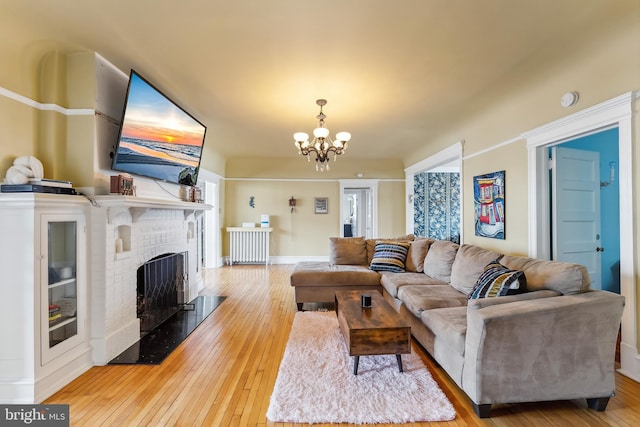 1 S Bartram Ave Unit 3, Atlantic City, NJ 08401 - living area with a fireplace, a chandelier, hardwood / wood-style flooring, and baseboards