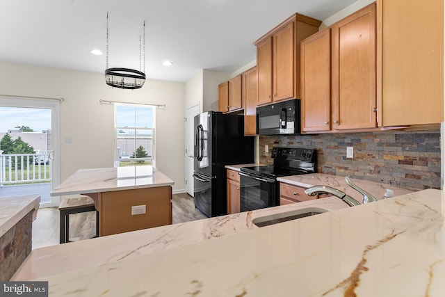 326 Iannelli Rd, Clarksboro, NJ 08020 - kitchen featuring black appliances, backsplash, a center island, a sink, and light stone counters