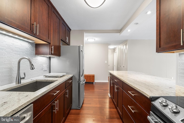 1919 Chestnut St Unit 715, Philadelphia, PA 19103 - kitchen featuring a sink, dark wood-style flooring, decorative backsplash, light stone countertops, and recessed lighting