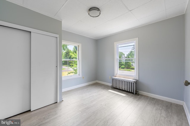 624 Hunt Ave, Trenton, NJ 08610 - unfurnished bedroom with radiator, baseboards, wood finished floors, and a closet