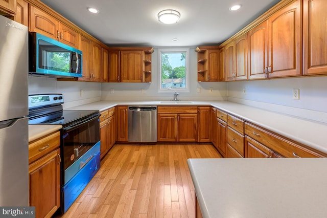 624 Hunt Ave, Trenton, NJ 08610 - kitchen with appliances with stainless steel finishes, open shelves, light wood-style flooring, a sink, and brown cabinets