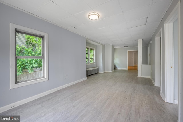 624 Hunt Ave, Trenton, NJ 08610 - unfurnished room with radiator, light wood finished floors, baseboards, and a drop ceiling