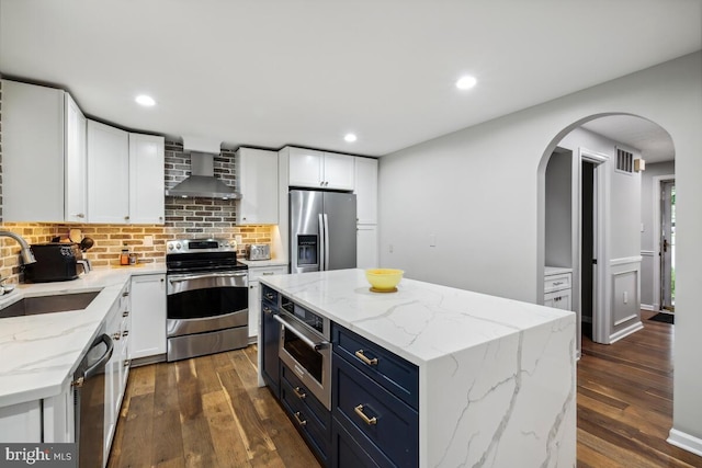 11636 Doxdam Ter, Germantown, MD 20876 - kitchen featuring appliances with stainless steel finishes, wall chimney range hood, a sink, dark wood-style flooring, and recessed lighting