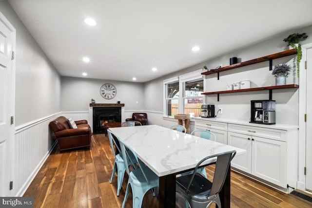 11636 Doxdam Ter, Germantown, MD 20876 - dining room featuring a wainscoted wall, dark wood finished floors, a warm lit fireplace, and recessed lighting