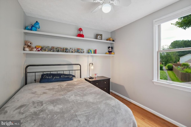 11636 Doxdam Ter, Germantown, MD 20876 - bedroom featuring wood finished floors, multiple windows, and baseboards