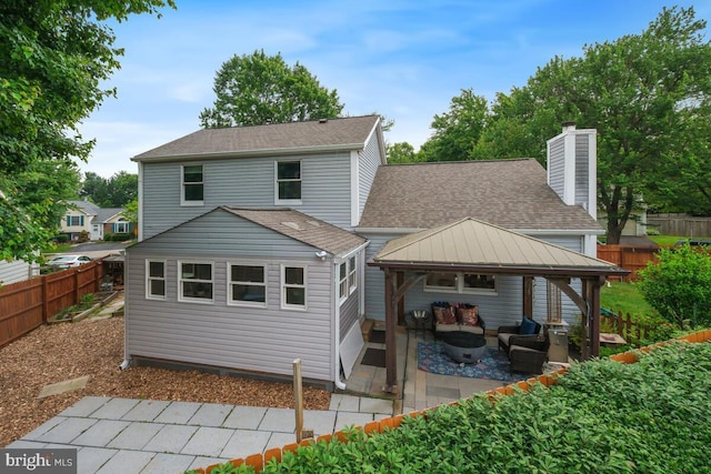 11636 Doxdam Ter, Germantown, MD 20876 - rear view of house featuring an outdoor hangout area, a gazebo, a patio area, a shingled roof, and a chimney