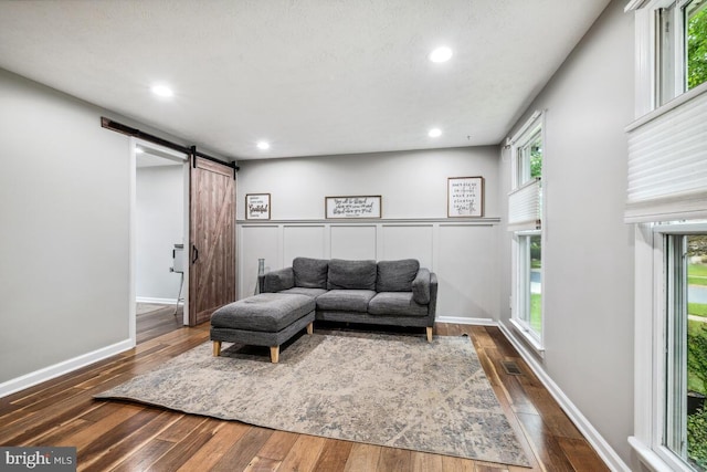 11636 Doxdam Ter, Germantown, MD 20876 - living area featuring a barn door, dark wood-type flooring, and recessed lighting