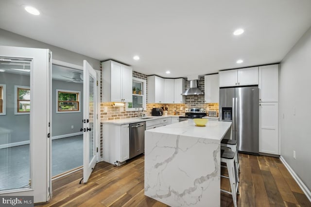 11636 Doxdam Ter, Germantown, MD 20876 - kitchen with stainless steel appliances, a sink, wall chimney exhaust hood, dark wood-style floors, and decorative backsplash