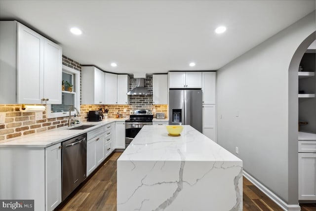 11636 Doxdam Ter, Germantown, MD 20876 - kitchen with appliances with stainless steel finishes, wall chimney exhaust hood, a sink, arched walkways, and dark wood-type flooring