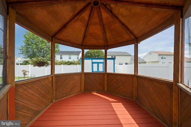 123 E Violette Dr, New Castle, DE 19720 - unfurnished sunroom with a residential view and vaulted ceiling