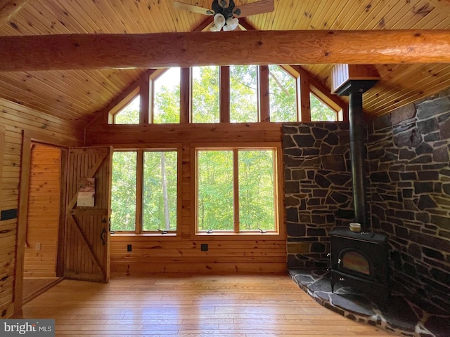 11882 Bumbarger Cir, Petersburg, PA 16669 - unfurnished living room featuring a wood stove, light wood-style floors, wood ceiling with exposed beams, ceiling fan, and wooden walls