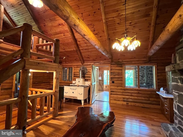 11882 Bumbarger Cir, Petersburg, PA 16669 - bedroom with wooden ceiling with exposed beams, hardwood / wood-style floors, rustic walls, a chandelier, and high vaulted ceiling
