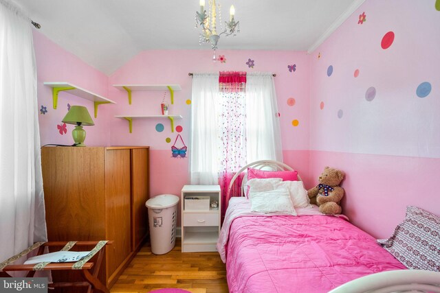 5409 20th Ave, Hyattsville, MD 20782 - bedroom with wood finished floors, vaulted ceiling, and a chandelier