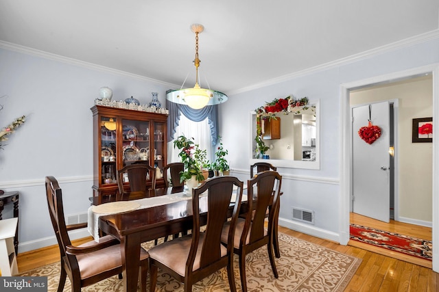 5409 20th Ave, Hyattsville, MD 20782 - dining room featuring light wood-style flooring, crown molding, and baseboards