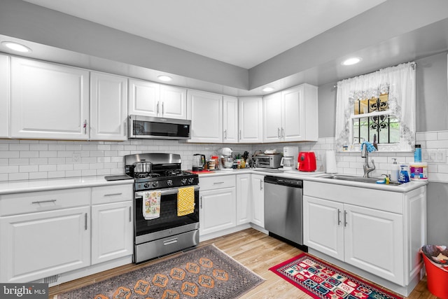 5409 20th Ave, Hyattsville, MD 20782 - kitchen with appliances with stainless steel finishes, a sink, light wood finished floors, light countertops, and recessed lighting