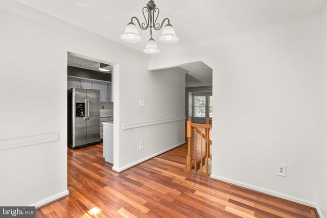 7967 Brightmeadow Ct, Ellicott City, MD 21043 - unfurnished dining area featuring wood finished floors and a chandelier
