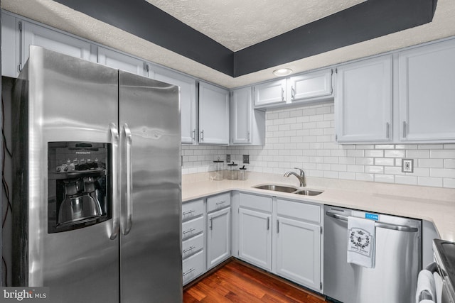 7967 Brightmeadow Ct, Ellicott City, MD 21043 - kitchen with stainless steel appliances, light countertops, dark wood finished floors, a textured ceiling, and tasteful backsplash