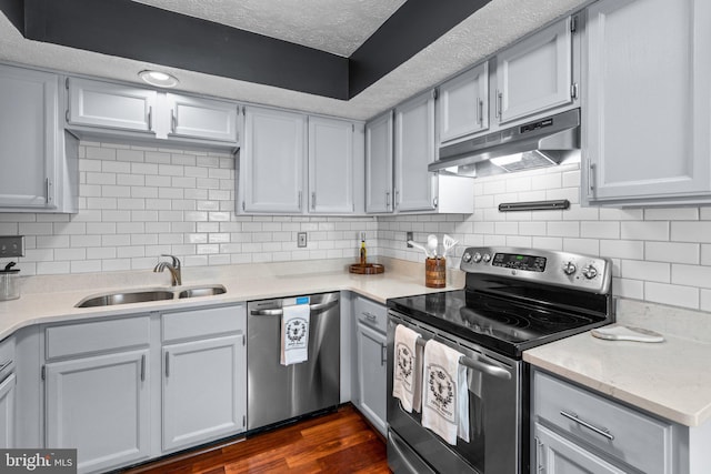 7967 Brightmeadow Ct, Ellicott City, MD 21043 - kitchen featuring appliances with stainless steel finishes, under cabinet range hood, a textured ceiling, backsplash, and dark wood-type flooring