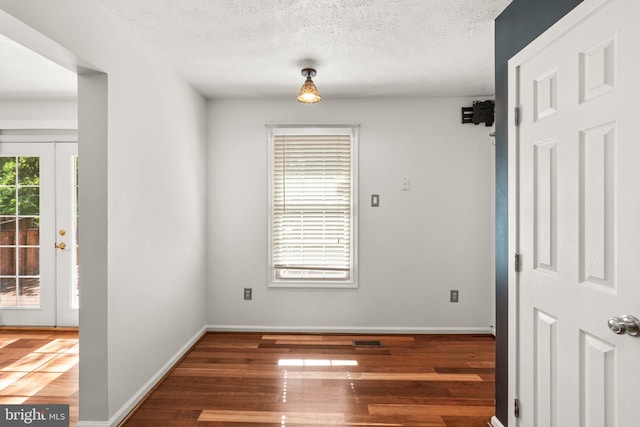 7967 Brightmeadow Ct, Ellicott City, MD 21043 - empty room with wood finished floors and a textured ceiling