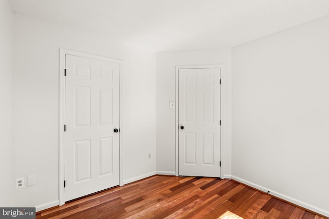 7967 Brightmeadow Ct, Ellicott City, MD 21043 - unfurnished bedroom featuring wood finished floors and baseboards