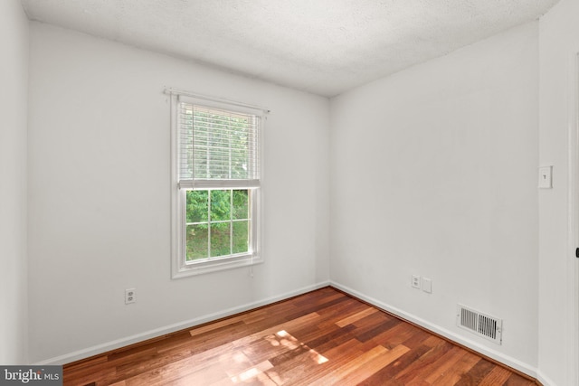 7967 Brightmeadow Ct, Ellicott City, MD 21043 - unfurnished room with healthy amount of natural light, wood finished floors, and a textured ceiling