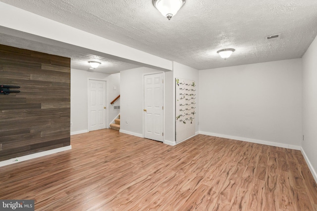 7967 Brightmeadow Ct, Ellicott City, MD 21043 - finished below grade area featuring wood finished floors, a textured ceiling, and stairs