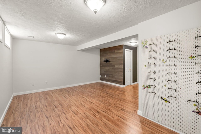 7967 Brightmeadow Ct, Ellicott City, MD 21043 - unfurnished room featuring a textured ceiling, wood finished floors, and a workshop area