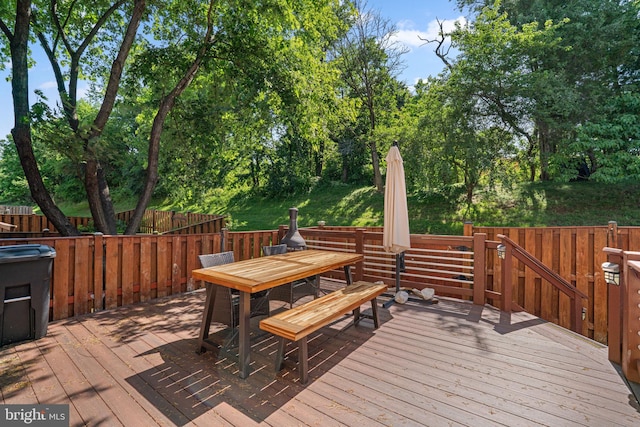 7967 Brightmeadow Ct, Ellicott City, MD 21043 - wooden deck with outdoor dining area and view of wooded area