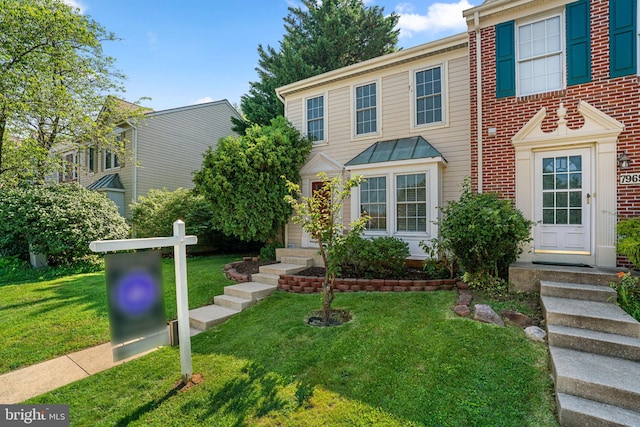 7967 Brightmeadow Ct, Ellicott City, MD 21043 - view of front of house with entry steps, a front lawn, brick siding, and a standing seam roof