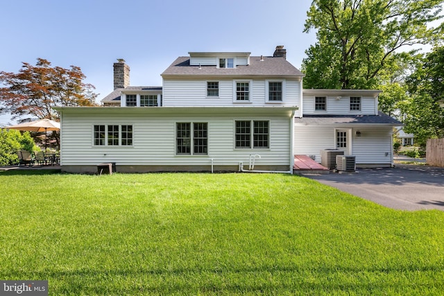 20 Aldwyn Ln, Villanova, PA 19085 - rear view of house featuring a chimney and a yard