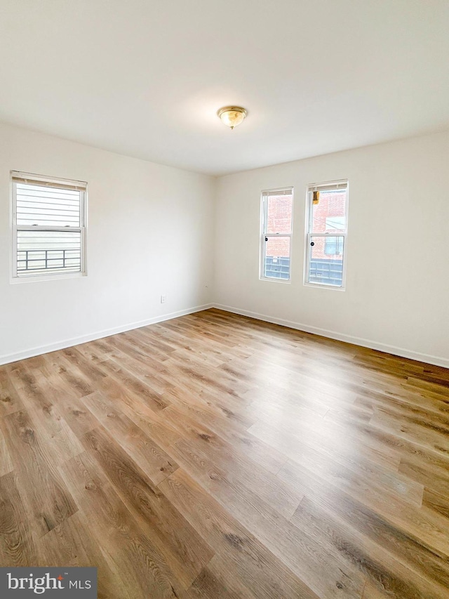 1308 Gallaudet St NE, Washington, DC 20002 - empty room with wood finished floors and baseboards