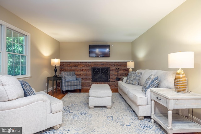 17 Bridleshire Rd, Newark, DE 19711 - living area with wood finished floors, a brick fireplace, and baseboards