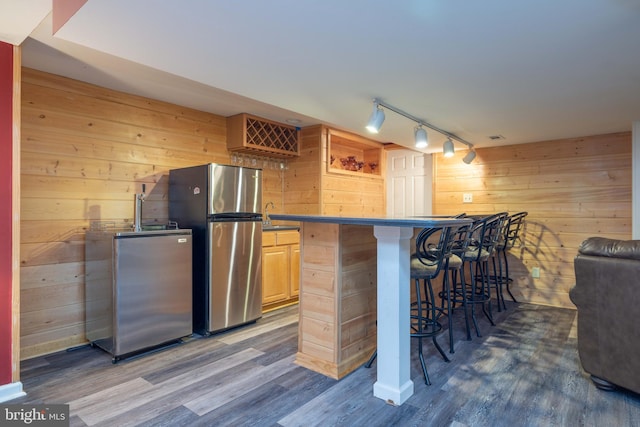 17 Bridleshire Rd, Newark, DE 19711 - indoor bar featuring wooden walls, freestanding refrigerator, track lighting, and wood finished floors