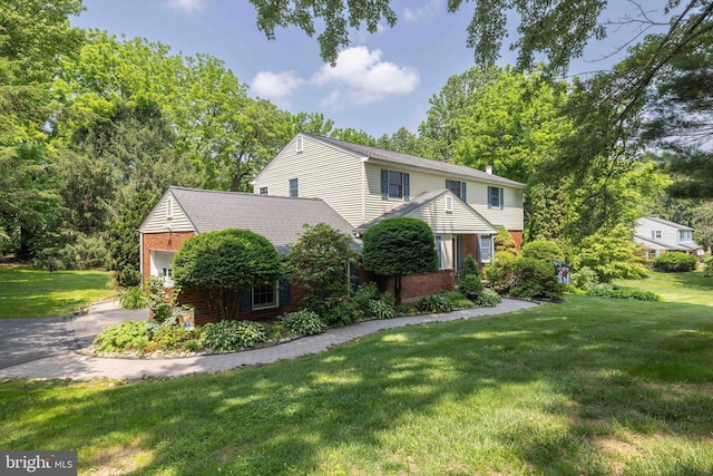 17 Bridleshire Rd, Newark, DE 19711 - view of front of house with brick siding, an attached garage, a front lawn, and asphalt driveway