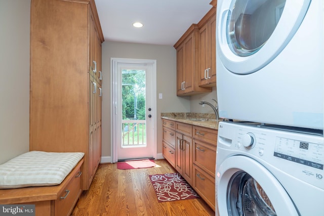 17 Bridleshire Rd, Newark, DE 19711 - washroom with stacked washer / drying machine, cabinet space, light wood-style flooring, recessed lighting, and baseboards