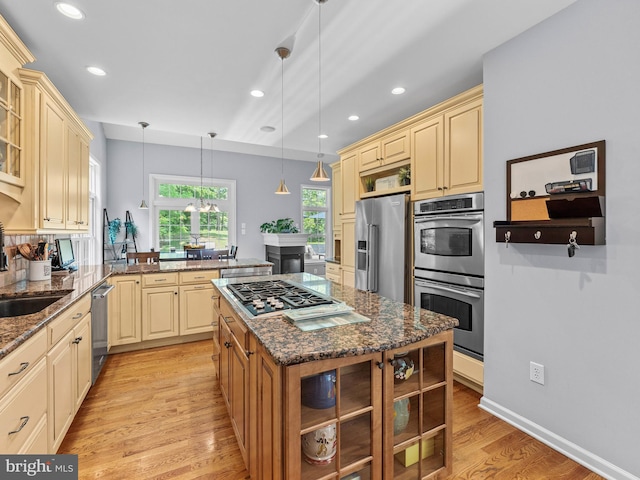 928 Township Line Rd, Chalfont, PA 18914 - kitchen with appliances with stainless steel finishes, cream cabinets, a peninsula, glass insert cabinets, and recessed lighting