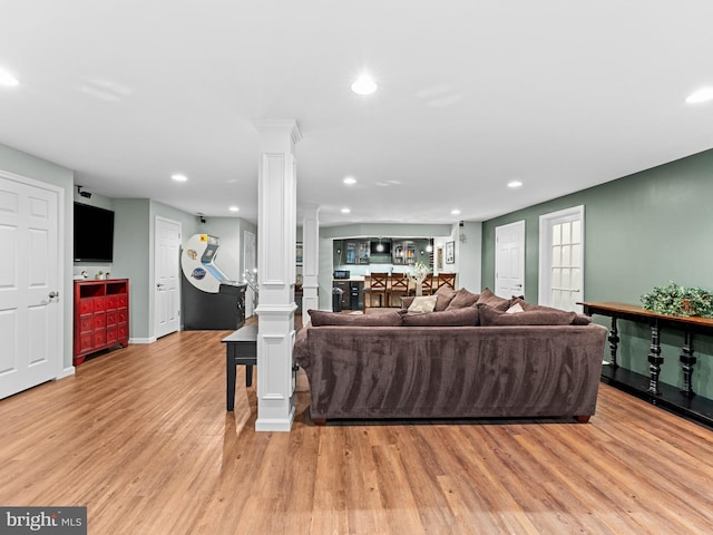928 Township Line Rd, Chalfont, PA 18914 - living room featuring decorative columns, light wood-style flooring, recessed lighting, and bar area
