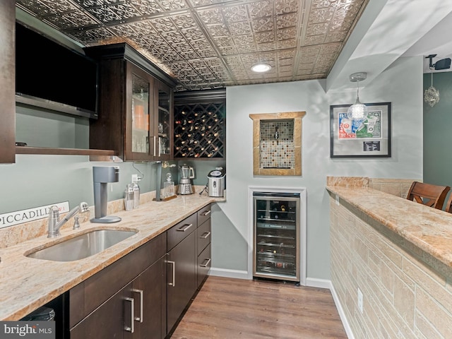 928 Township Line Rd, Chalfont, PA 18914 - indoor wet bar with beverage cooler, an ornate ceiling, light wood-type flooring, and decorative light fixtures