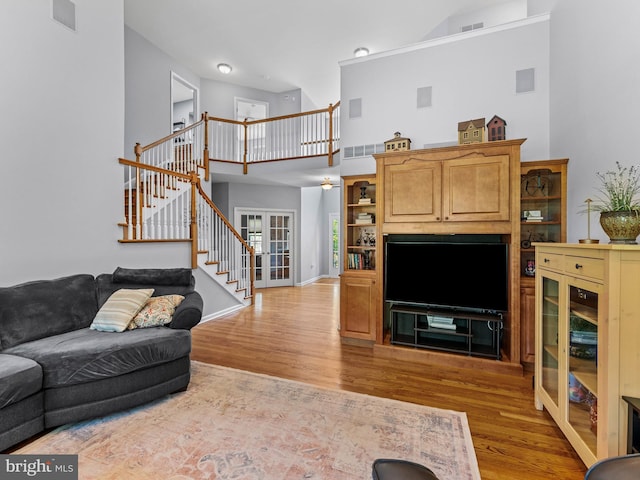 928 Township Line Rd, Chalfont, PA 18914 - living room featuring stairway, a high ceiling, light wood-style floors, and french doors