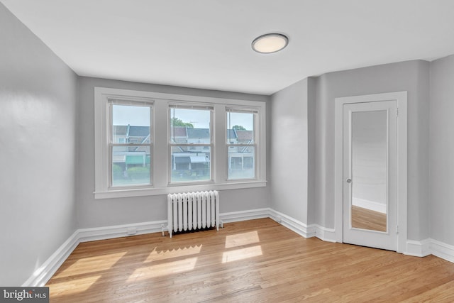 1004 N 67th St, Philadelphia, PA 19151 - empty room with radiator, light wood finished floors, and baseboards
