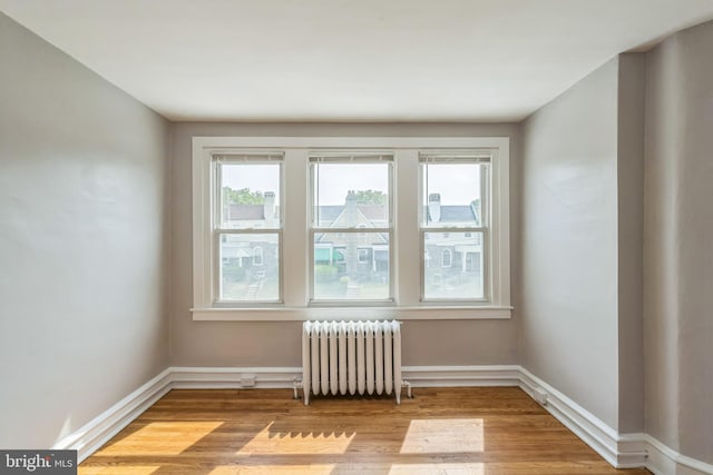 1004 N 67th St, Philadelphia, PA 19151 - unfurnished room featuring radiator, wood finished floors, and baseboards