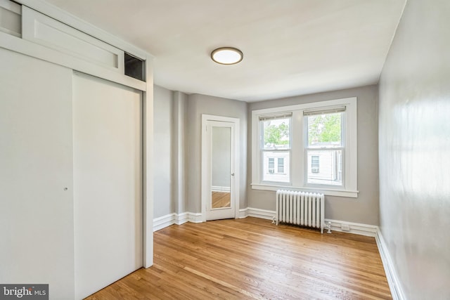 1004 N 67th St, Philadelphia, PA 19151 - unfurnished bedroom featuring radiator, light wood-style floors, and baseboards